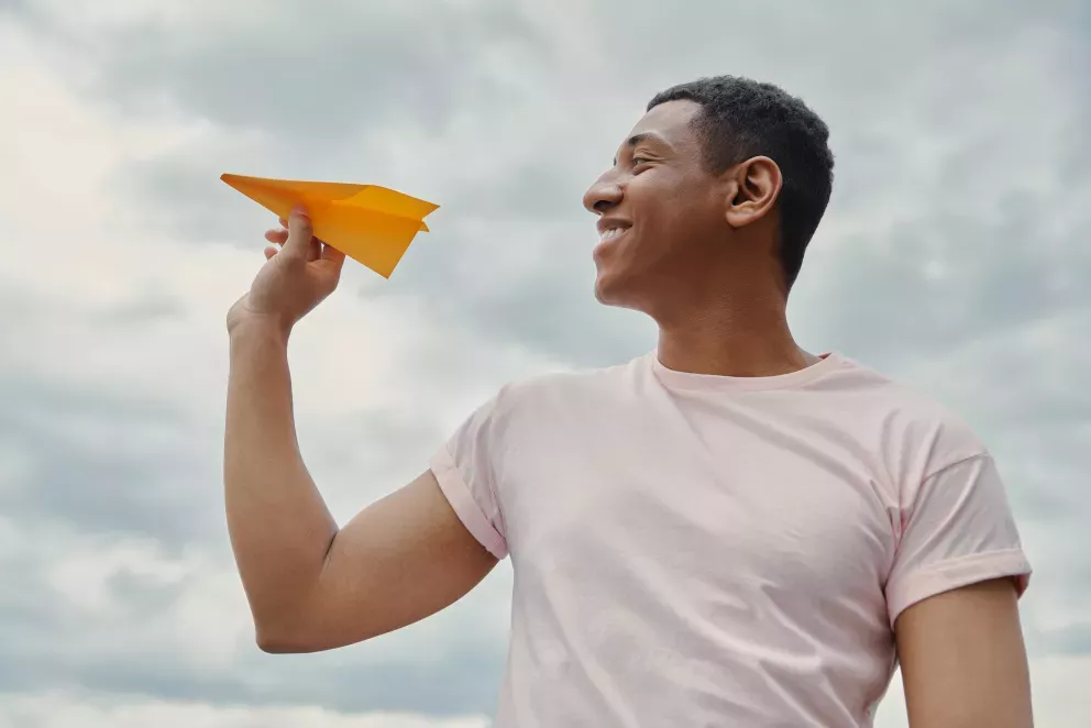 Man holding paper airplane 