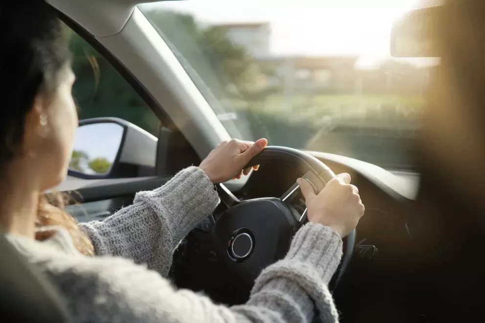 Woman focusing on the road while driving Woman focusing on the road while driving