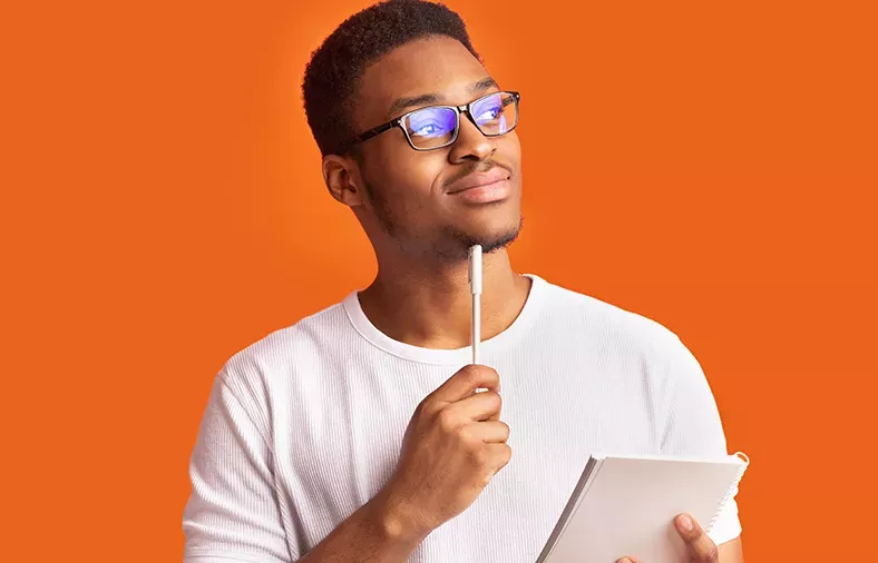 man holding pen and notebook