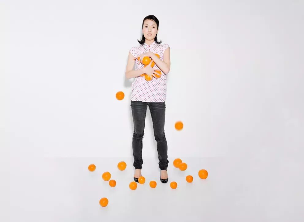 woman struggling to hold oranges woman struggling to hold oranges