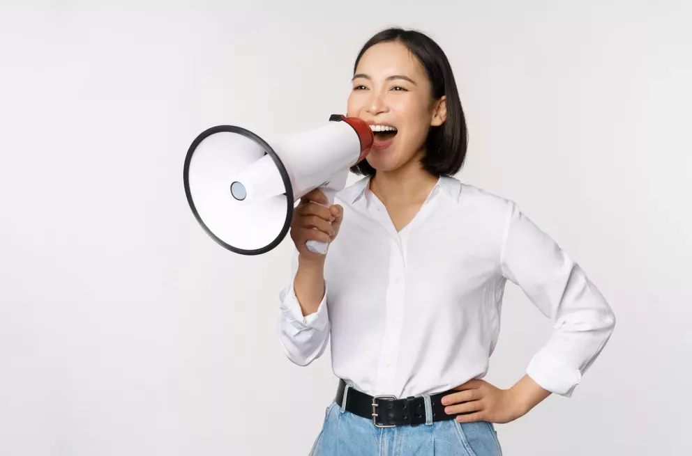 smiling person holding a loud speaker smiling person holding a loud speaker
