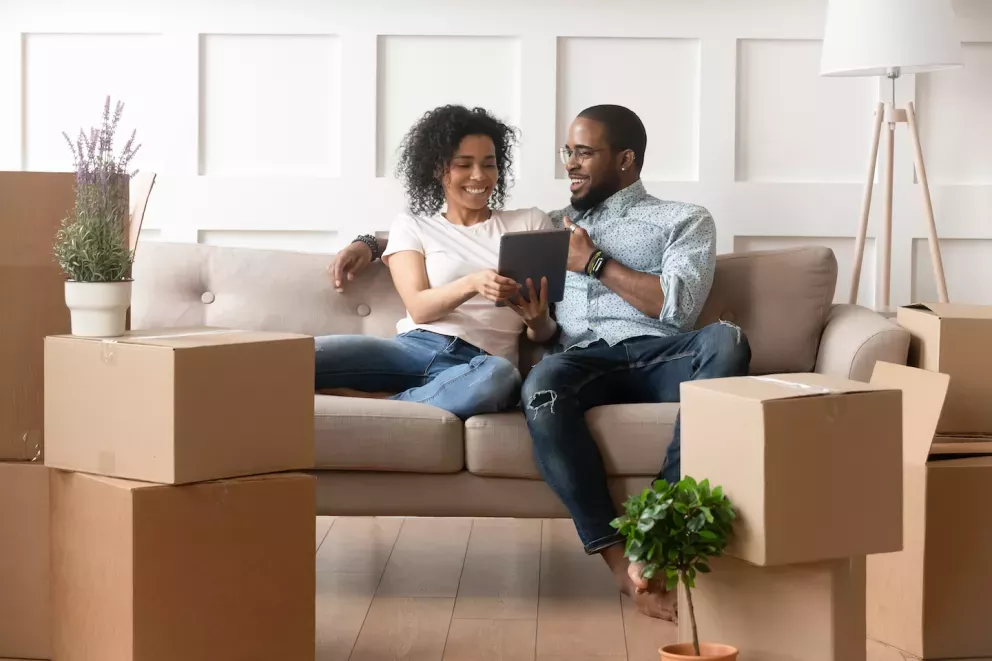 Couple looking at tablet in new home Couple looking at tablet in new home