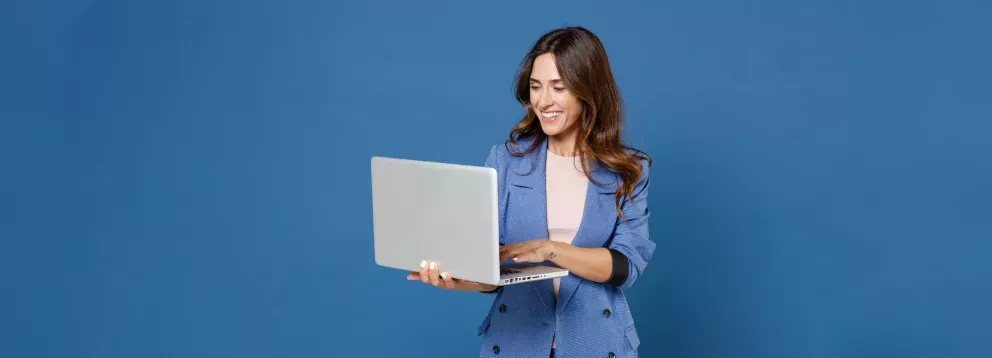 Woman in blue suit looking at laptop screen Woman in blue suit looking at laptop screen