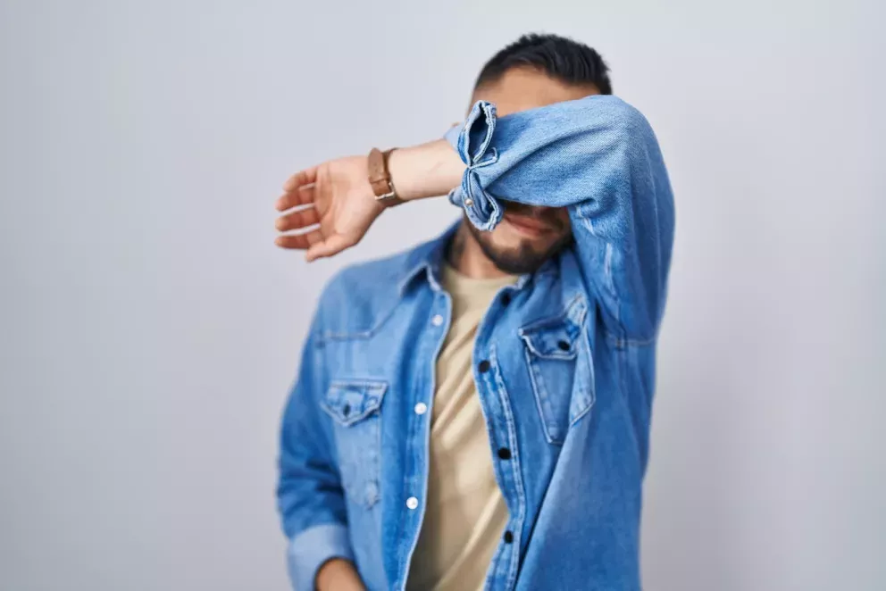 man covering his face man covering his face
