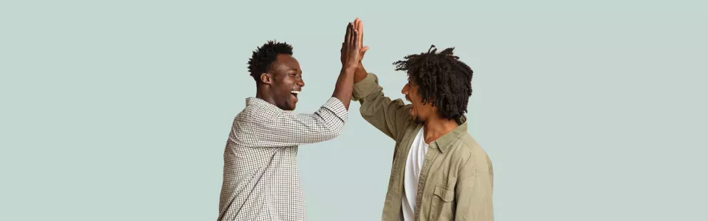 Men high fiving Men high fiving