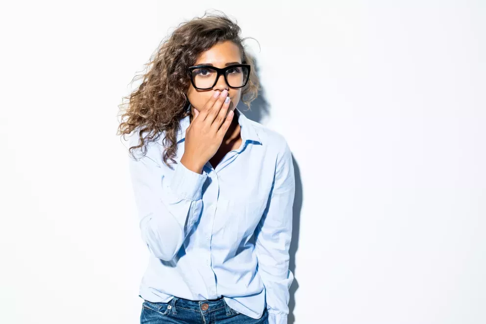 Woman with hand over mouth