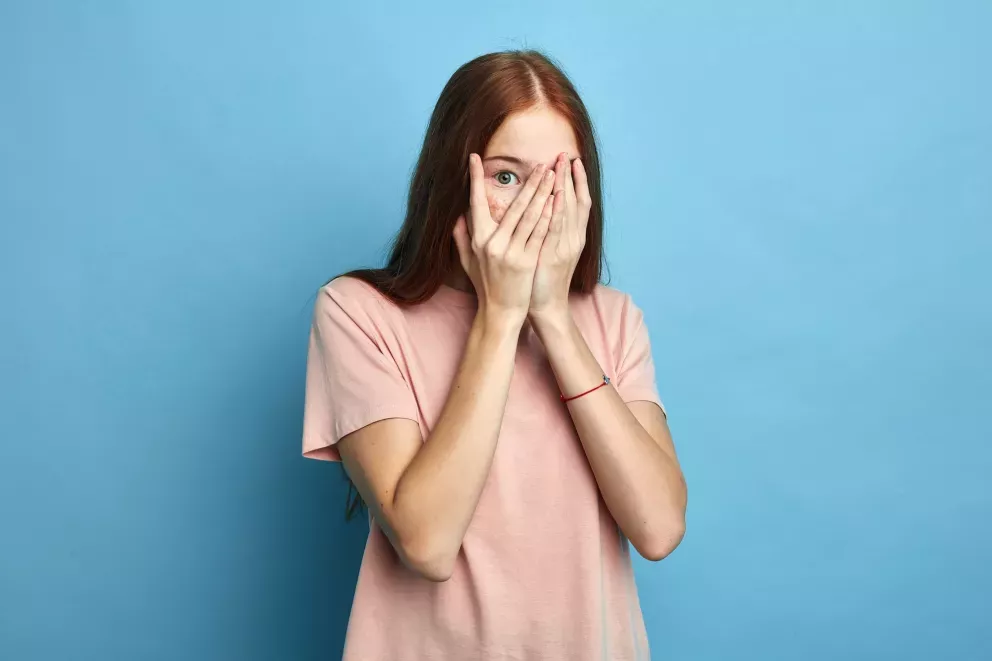 Woman hands over face