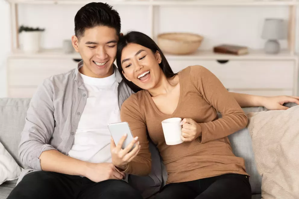 Asian couple on phone Asian couple on phone
