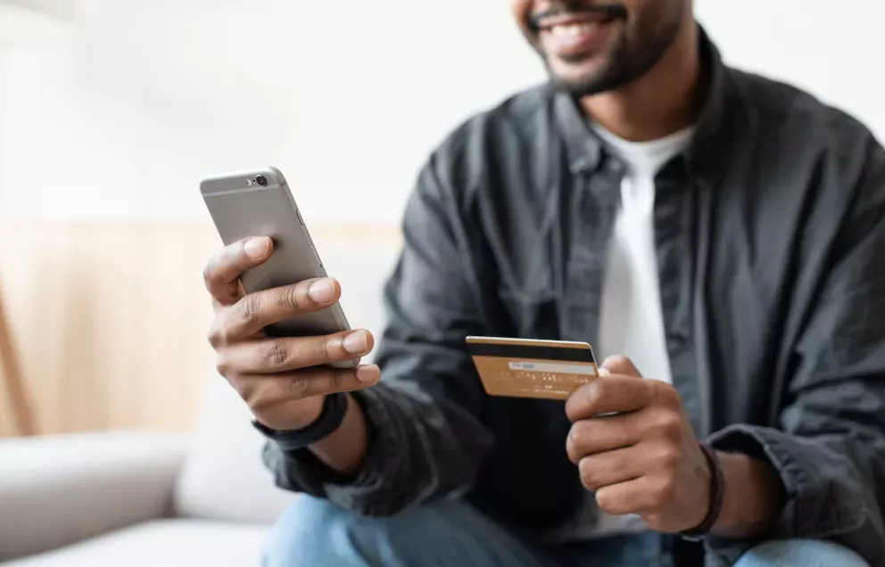 Man holding phone and card Man holding phone and card
