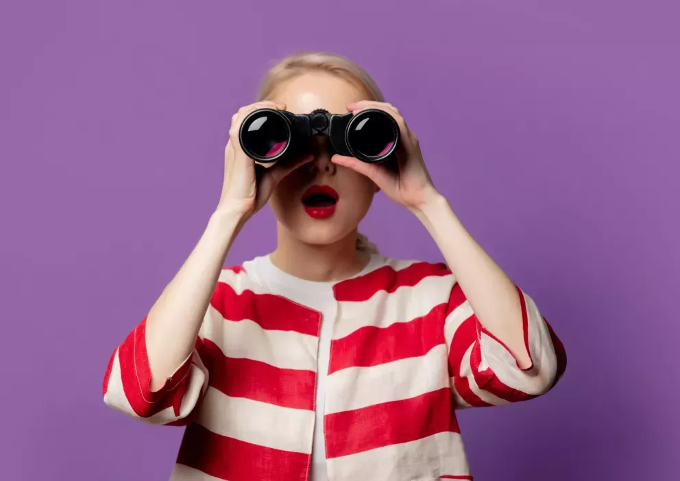 Woman looking through binoculars Woman looking through binoculars