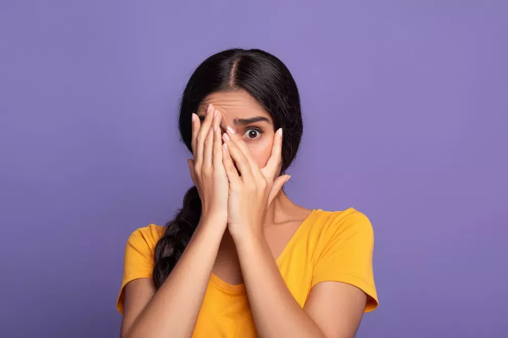 Woman covering eyes Woman covering eyes