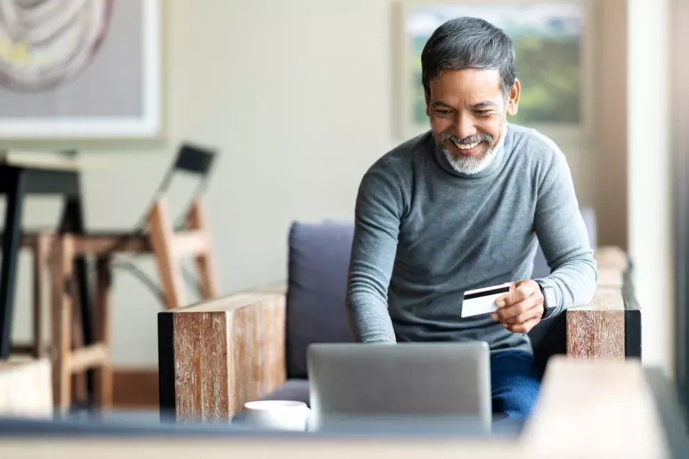 person smiling shopping on laptop computer person smiling shopping on laptop computer