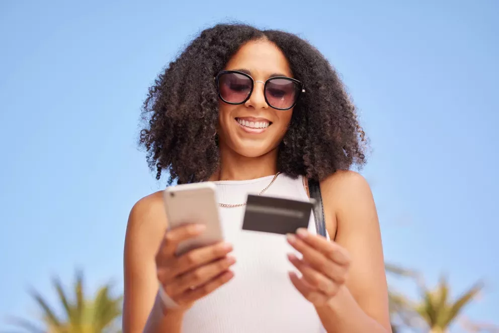 Woman with card and phone