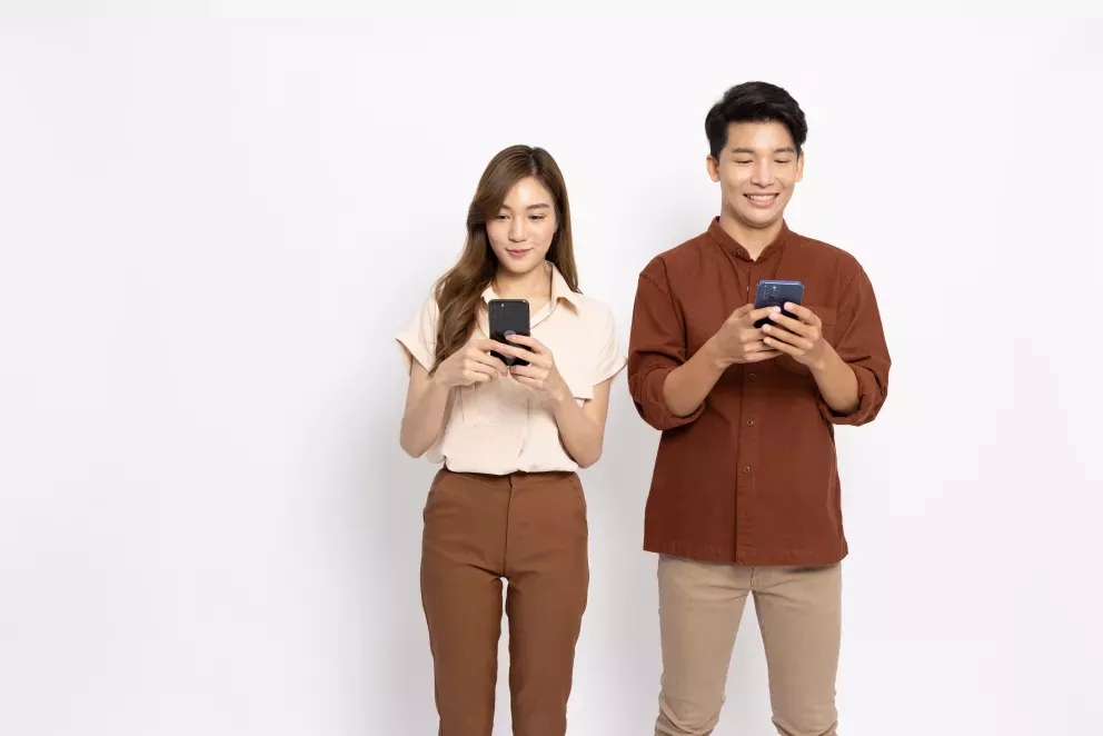 Man and woman with phones Man and woman with phones