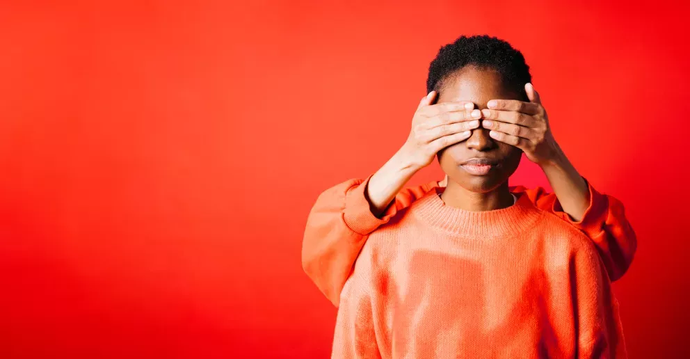 Woman with hand over face