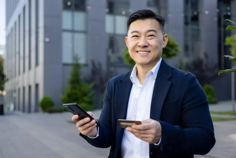 Man with phone and card Man with phone and card