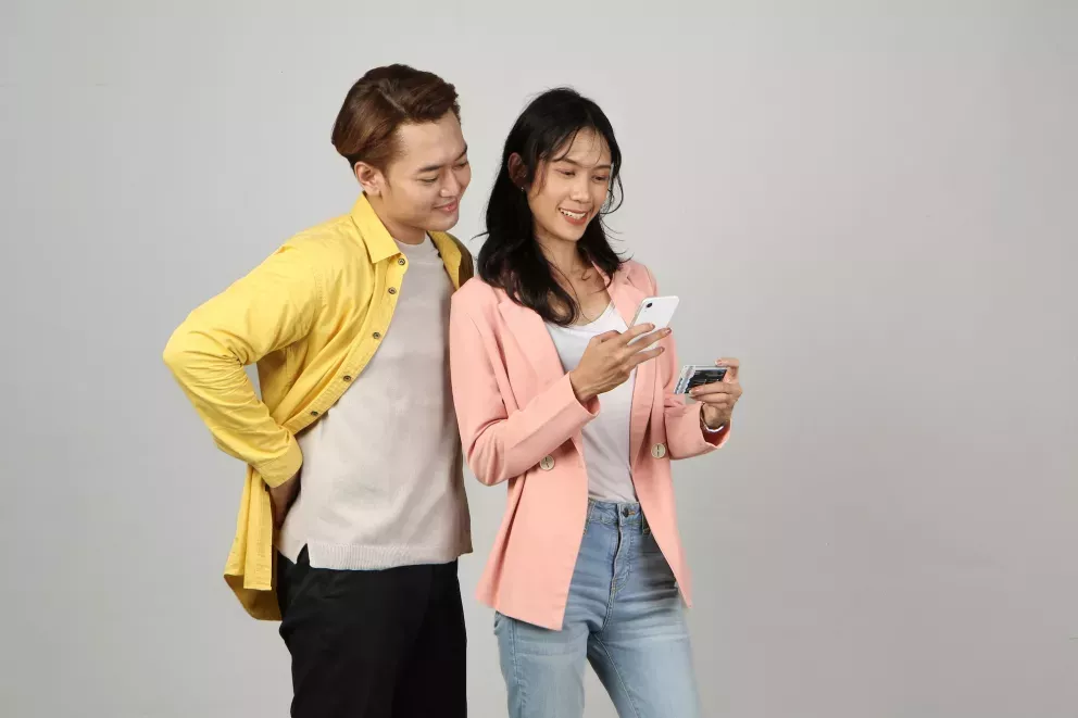 Man and woman with card and phone Man and woman with card and phone