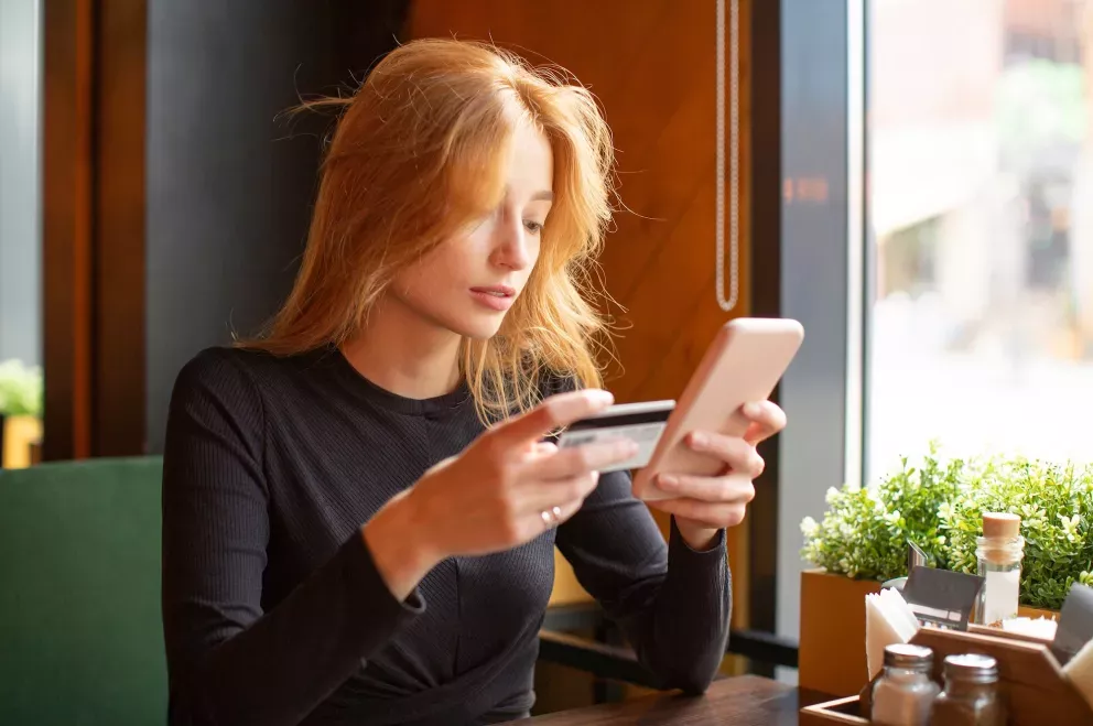 Woman with phone and card Woman with phone and card