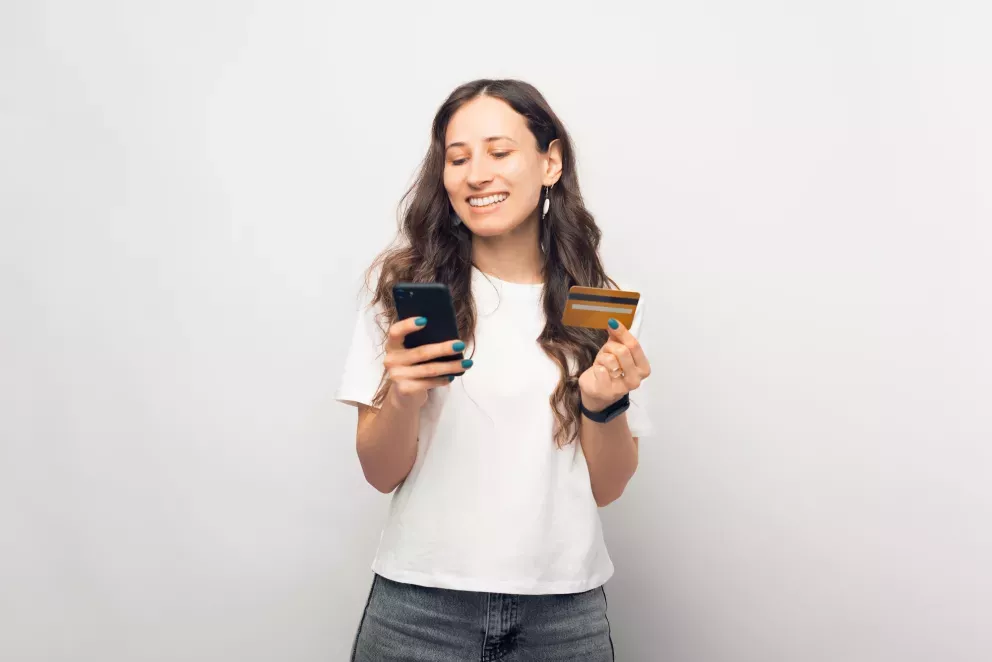 Woman with card and phone