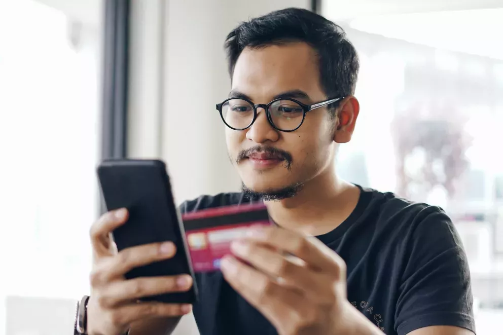 Man with phone and card