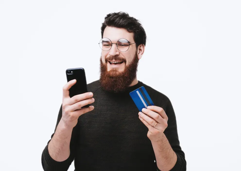 Man with phone and card Man with phone and card