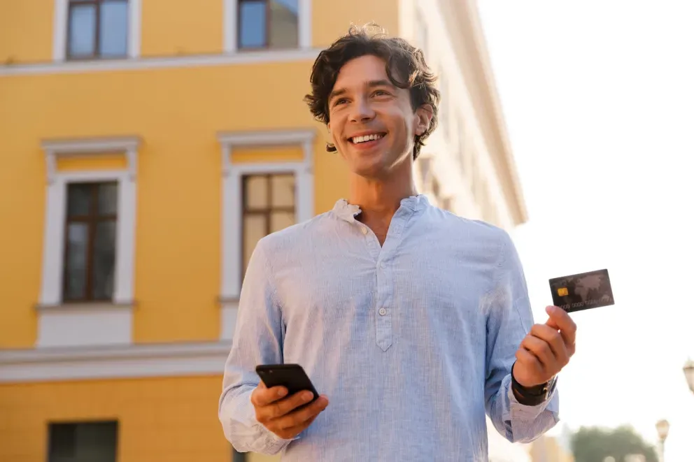 Man with phone and card Man with phone and card