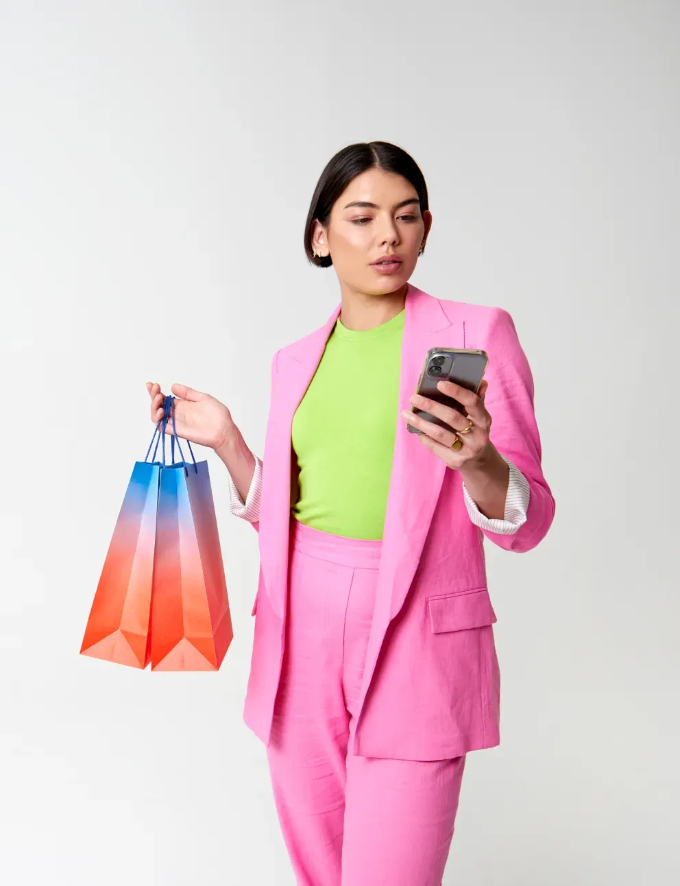 Woman with shopping bags looking at phone