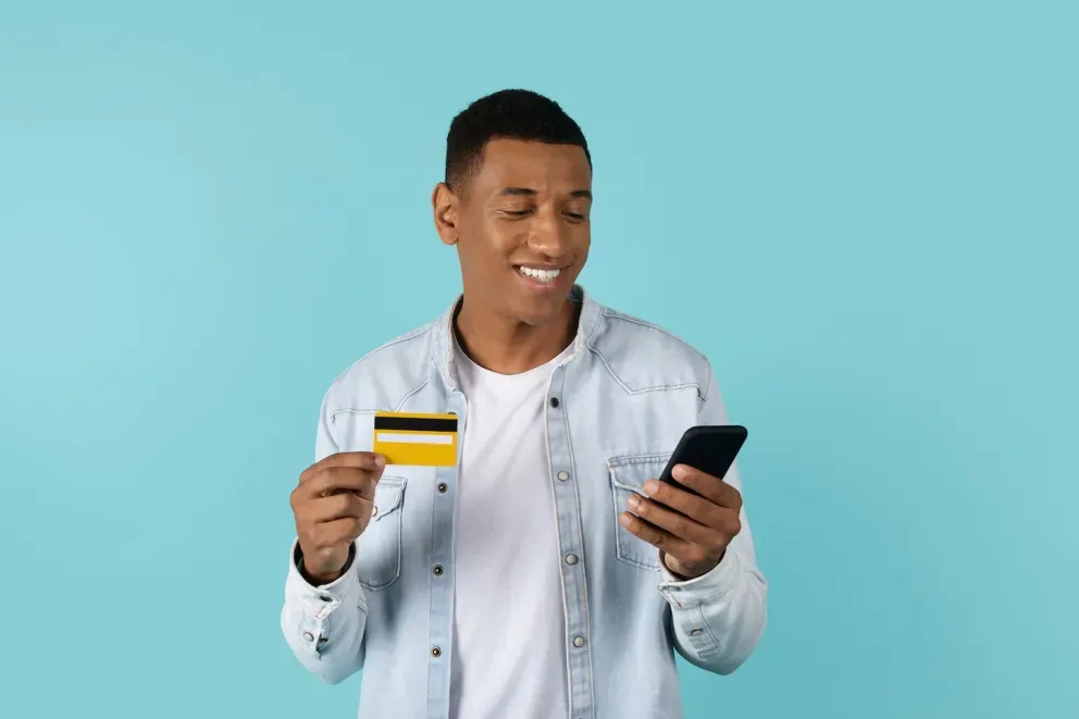 Man with card and phone