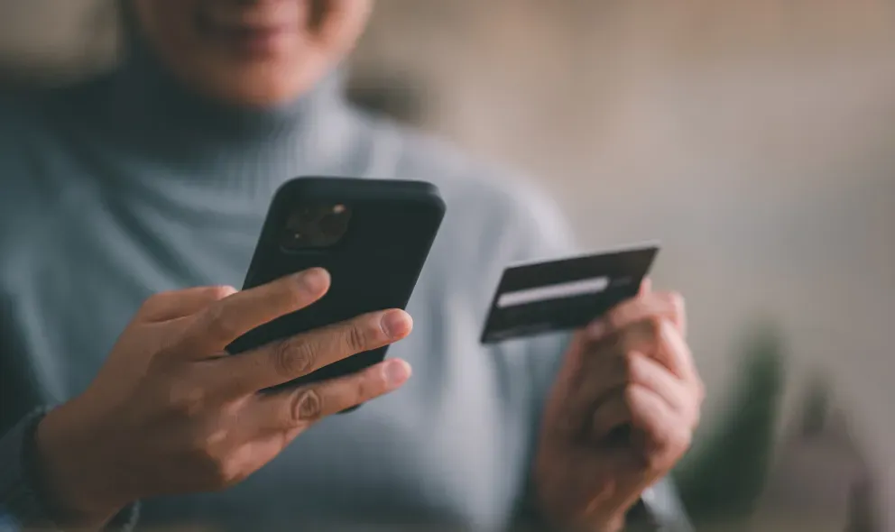 Woman with phone and card