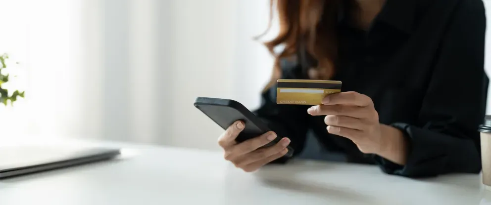 Woman with phone and card