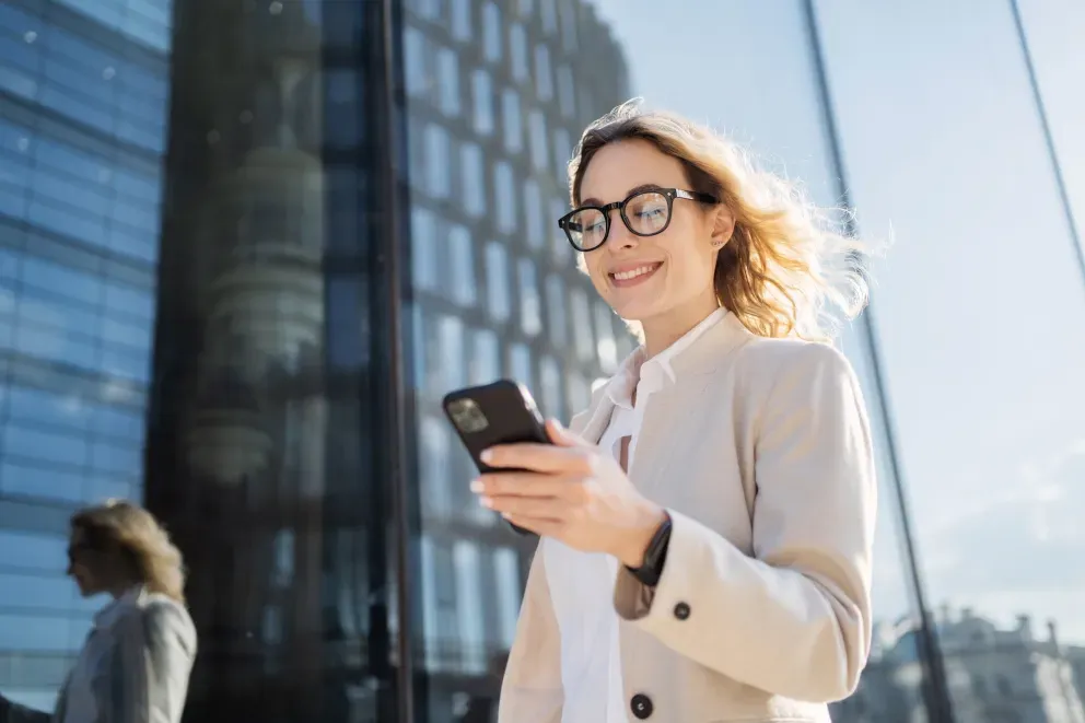 Business woman with phone outside