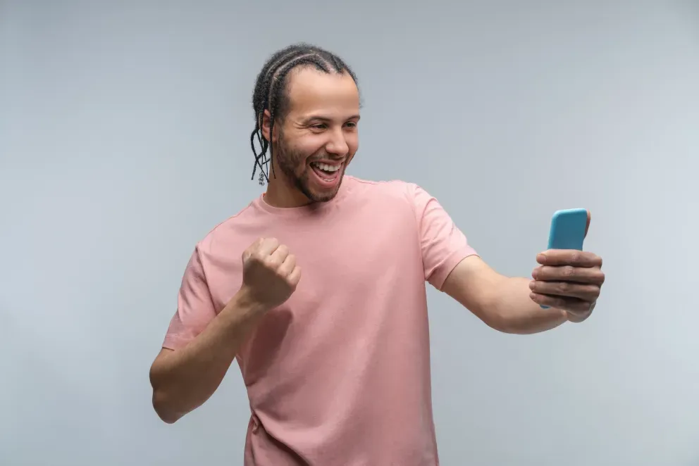 Excited young man with phone Excited young man with phone