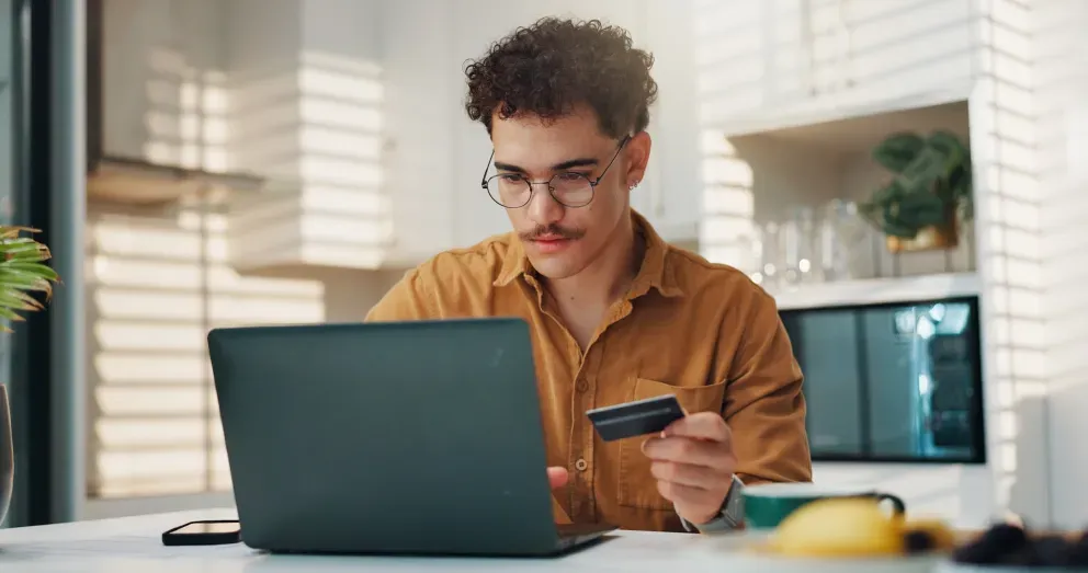 Man with laptop and credit card Man with laptop and credit card