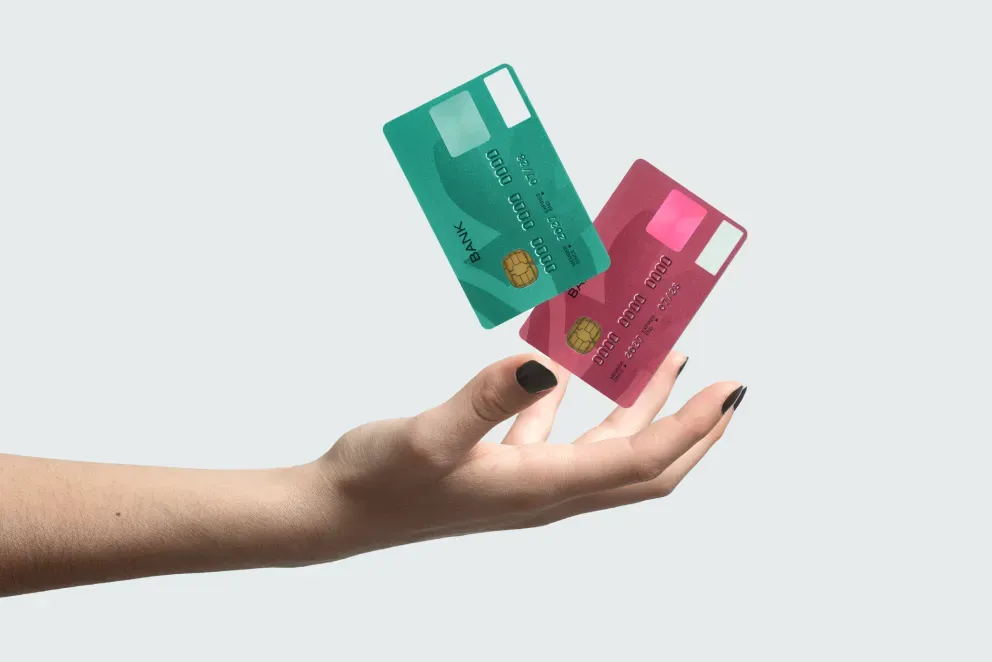 person holding credit cards person holding credit cards