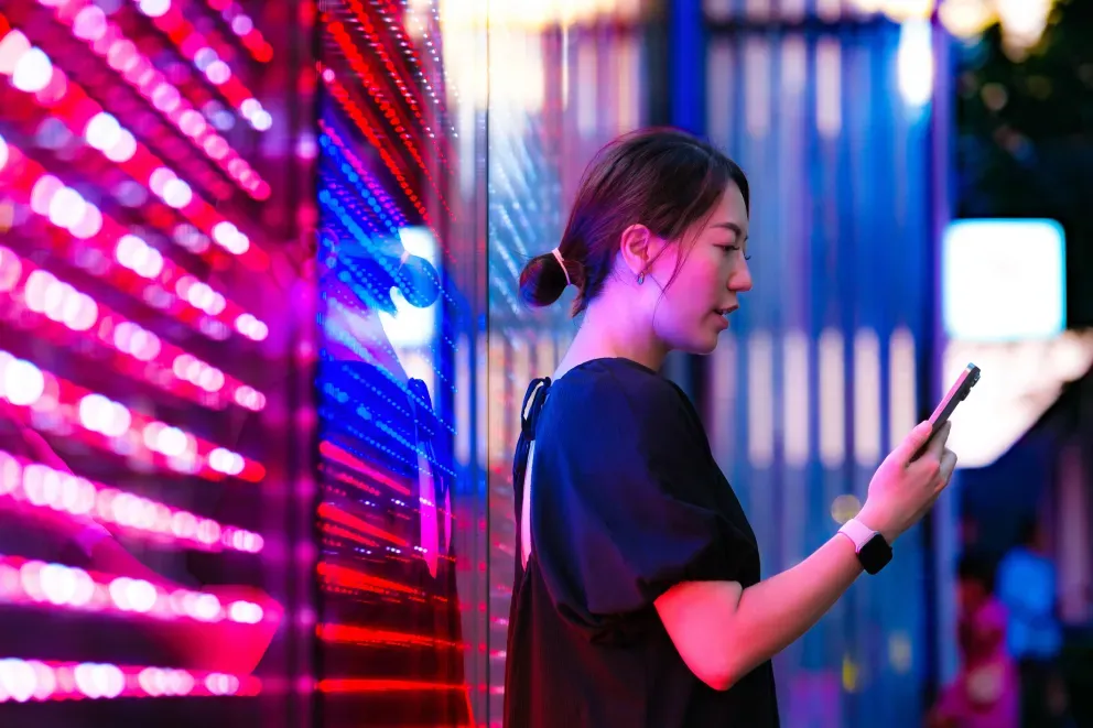 Woman with phone in server room Woman with phone in server room