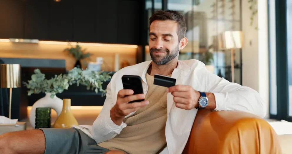 Person holding phone and credit card