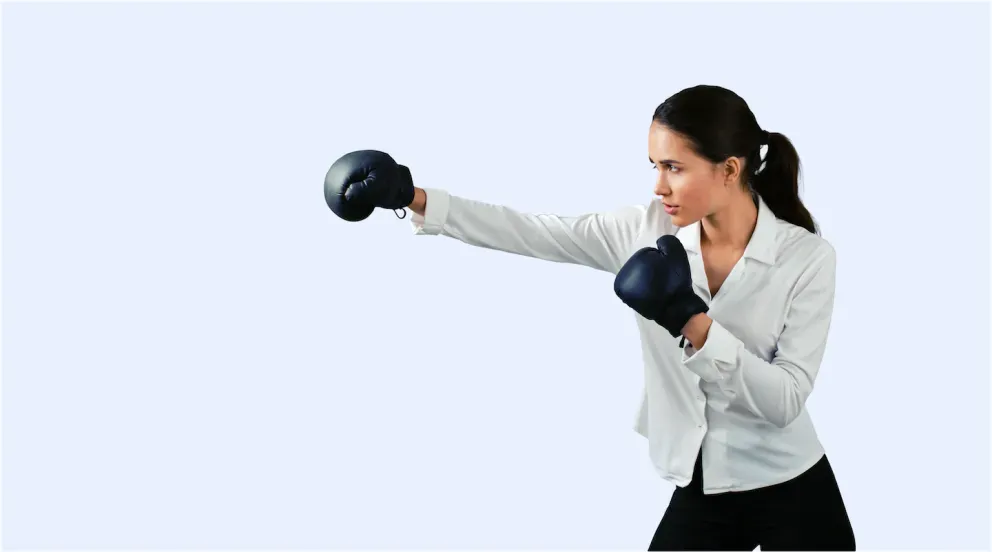 person with boxing gloves in fighting stance