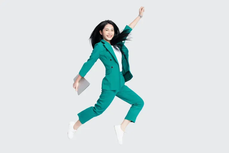 Woman in suit jumping with tablet Woman in suit jumping with tablet