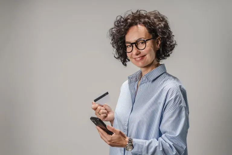 Person holding phone and credit card