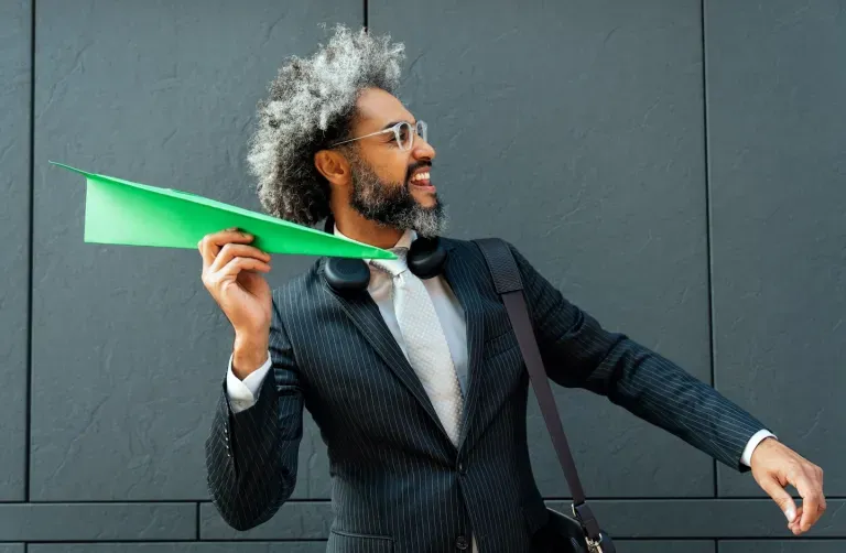 Person holding a paper plane