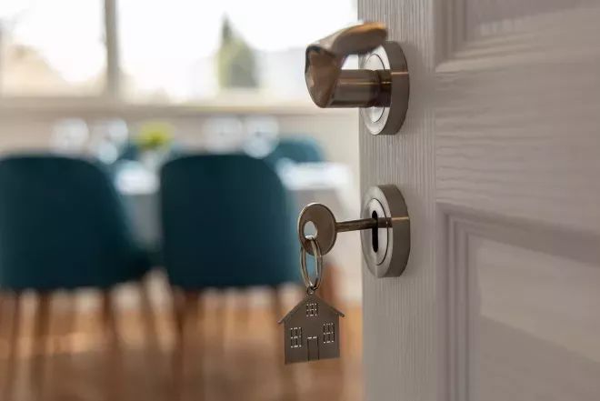 key in door opening to a new home