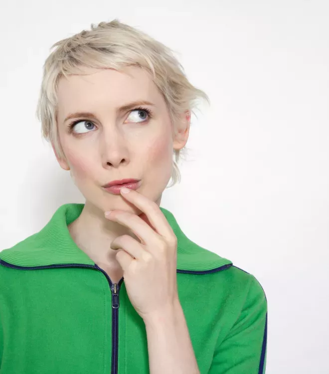 Woman in a green sweater thinking