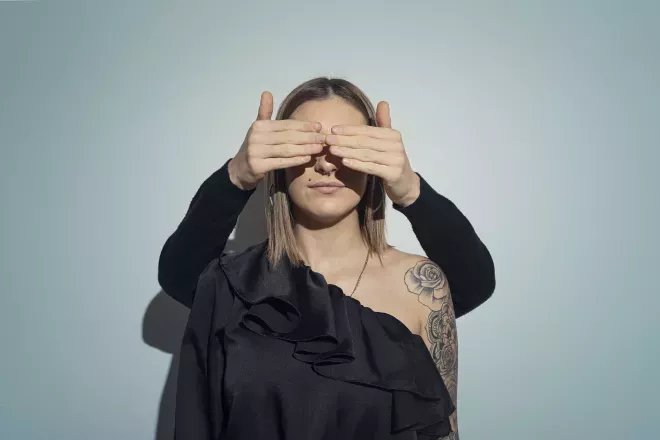 woman with hands covering her eyes