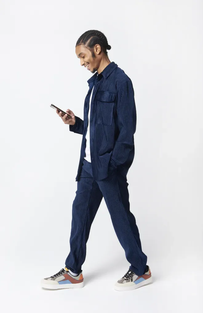 person walking using cell phone person walking using cell phone