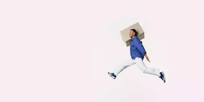 Man jumping with a box