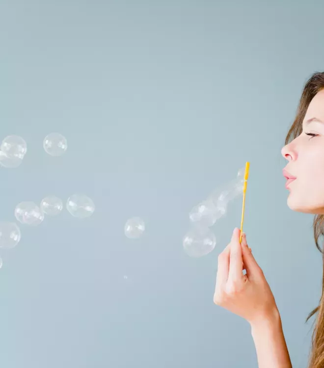 Woman blowing bubbles