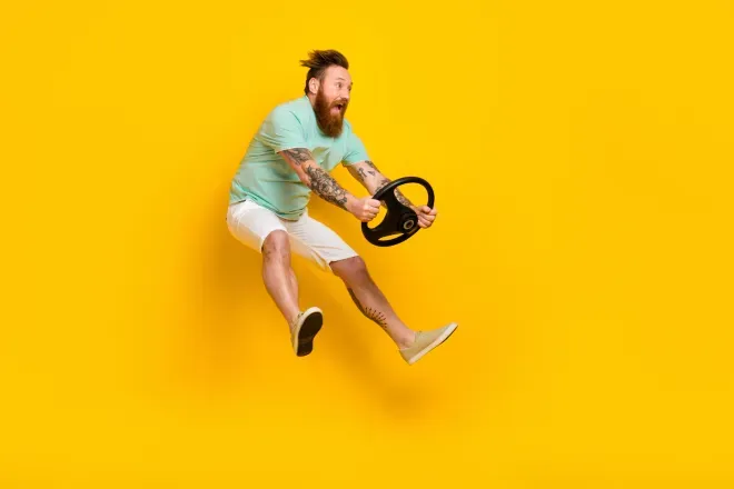Man holding on to a steering wheel