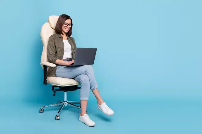 person sitting in chair on laptop