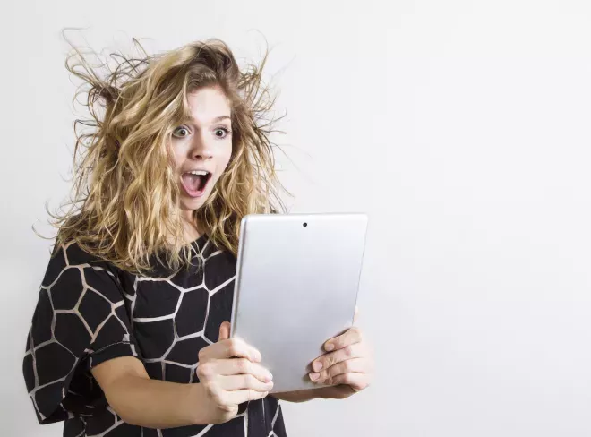 Happy woman looking at a tablet
