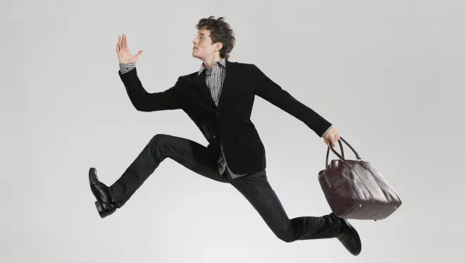 Business man leaping effortlessly 